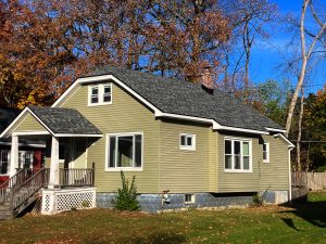 Close-up of a sleek black drip edge on a new roof enhancing curb appeal and durability.
