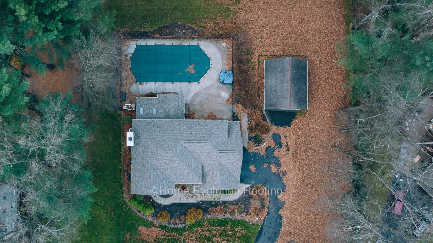 Professional roofer working on a residential roof in Scotia NY