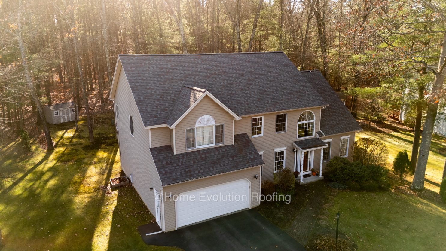 Roofer inspecting a residential roof in Johnstown NY