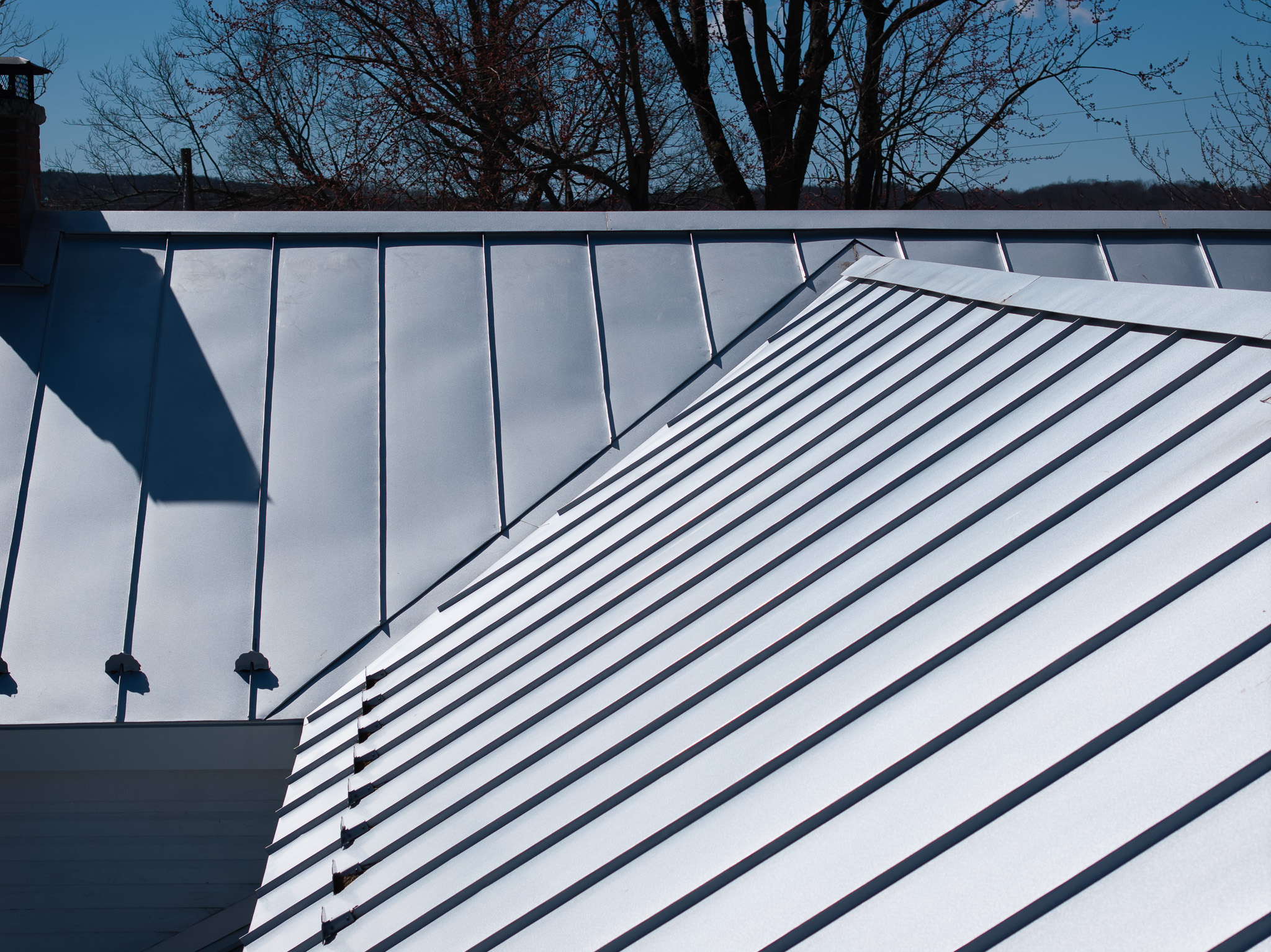 Metal roof on a Vermont home covered in snow near Stratton VT
