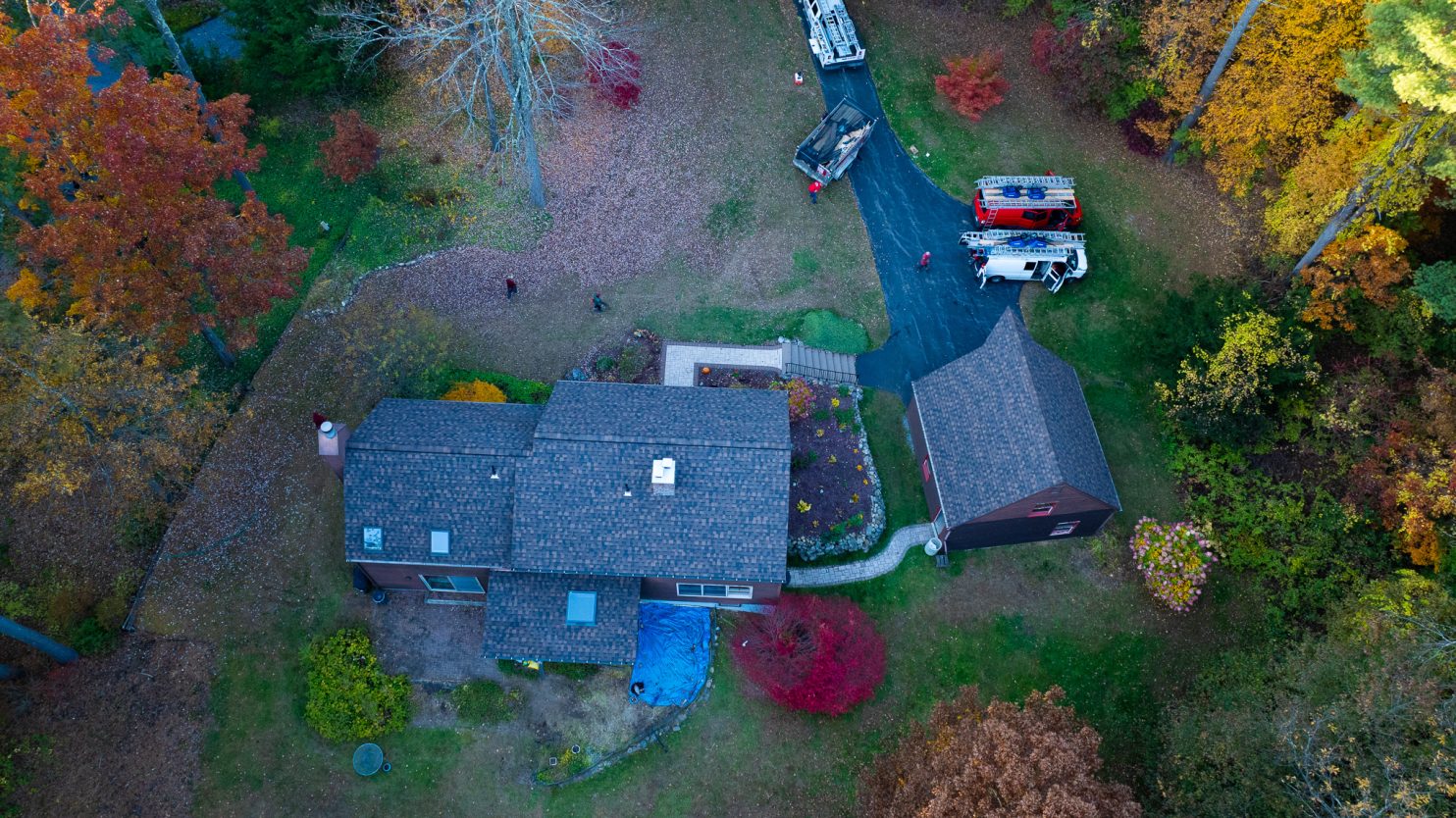 Roofing company crew installing shingles on a home in Oneonta NY