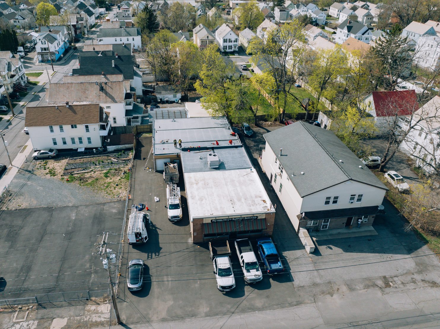 Roofing contractor in Utica NY working on commercial roof
