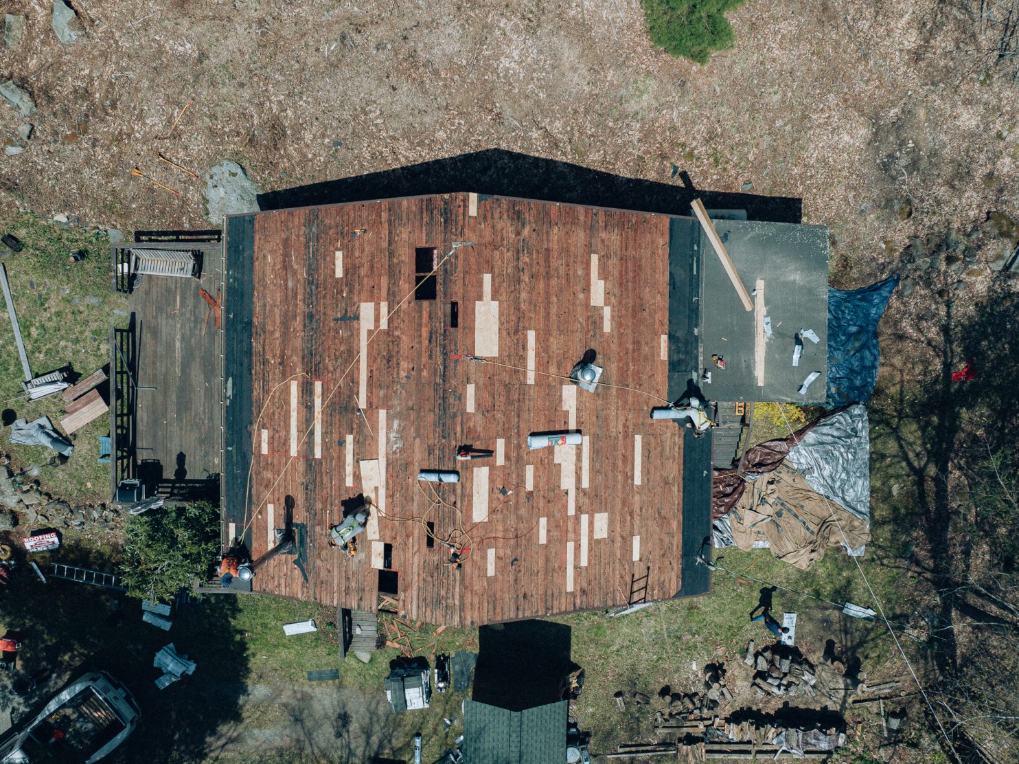 Roofing team working on a house in Utica NY