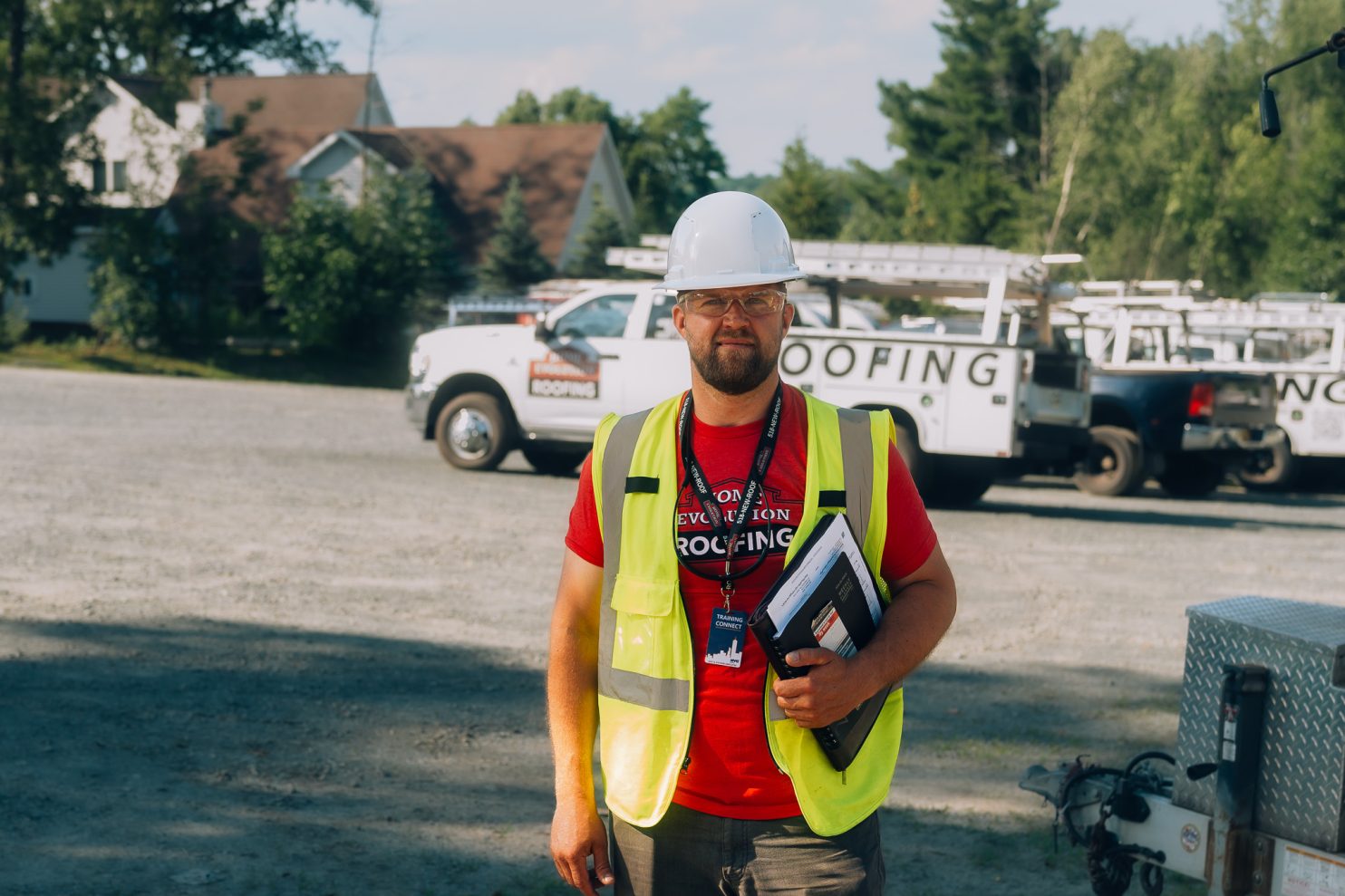 Roofing contractor inspecting roof in Albany NY during summer