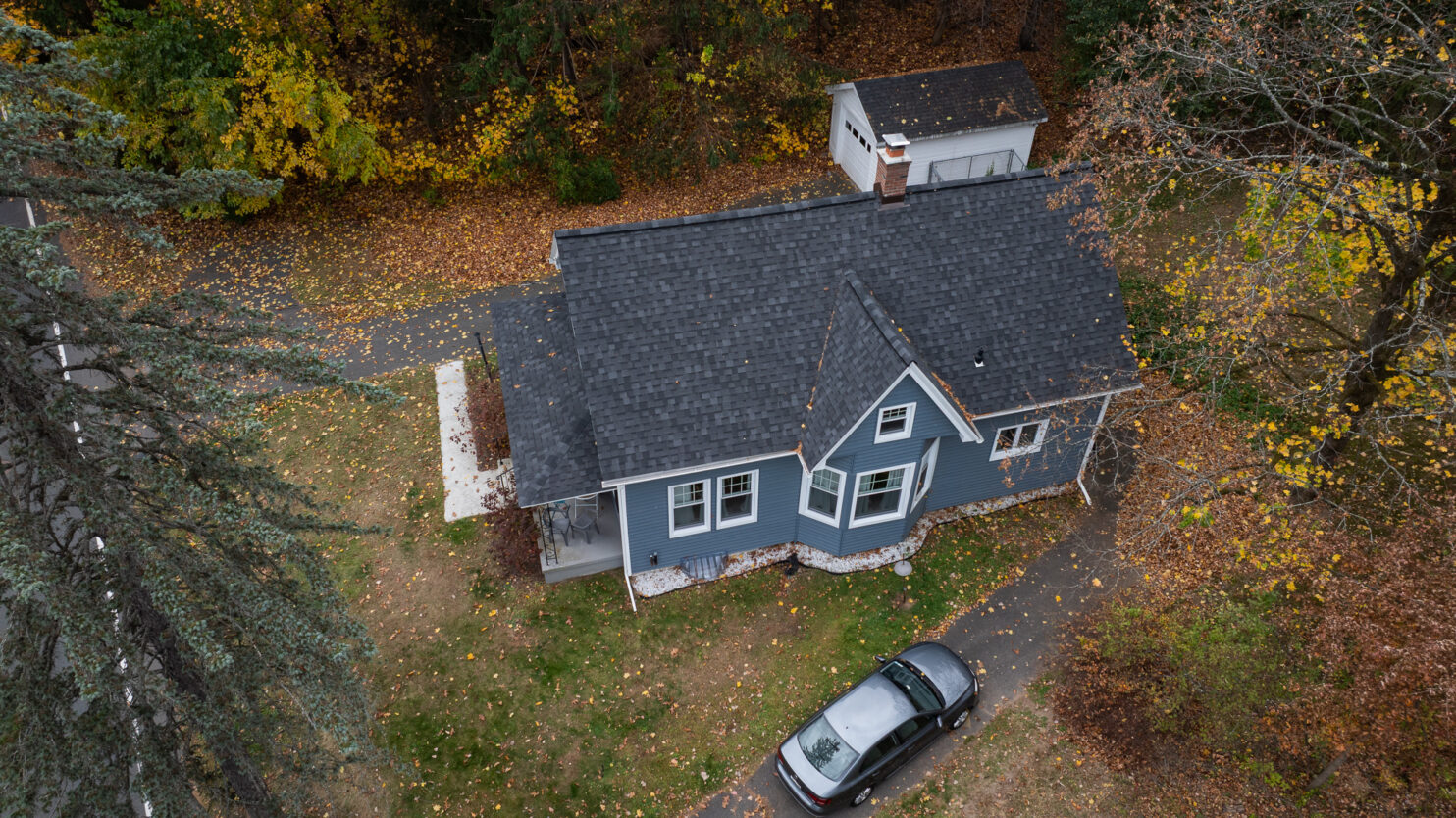 Emergency roof repair on a riverside home in Beacon NY with professional crew installing a protective tarp.