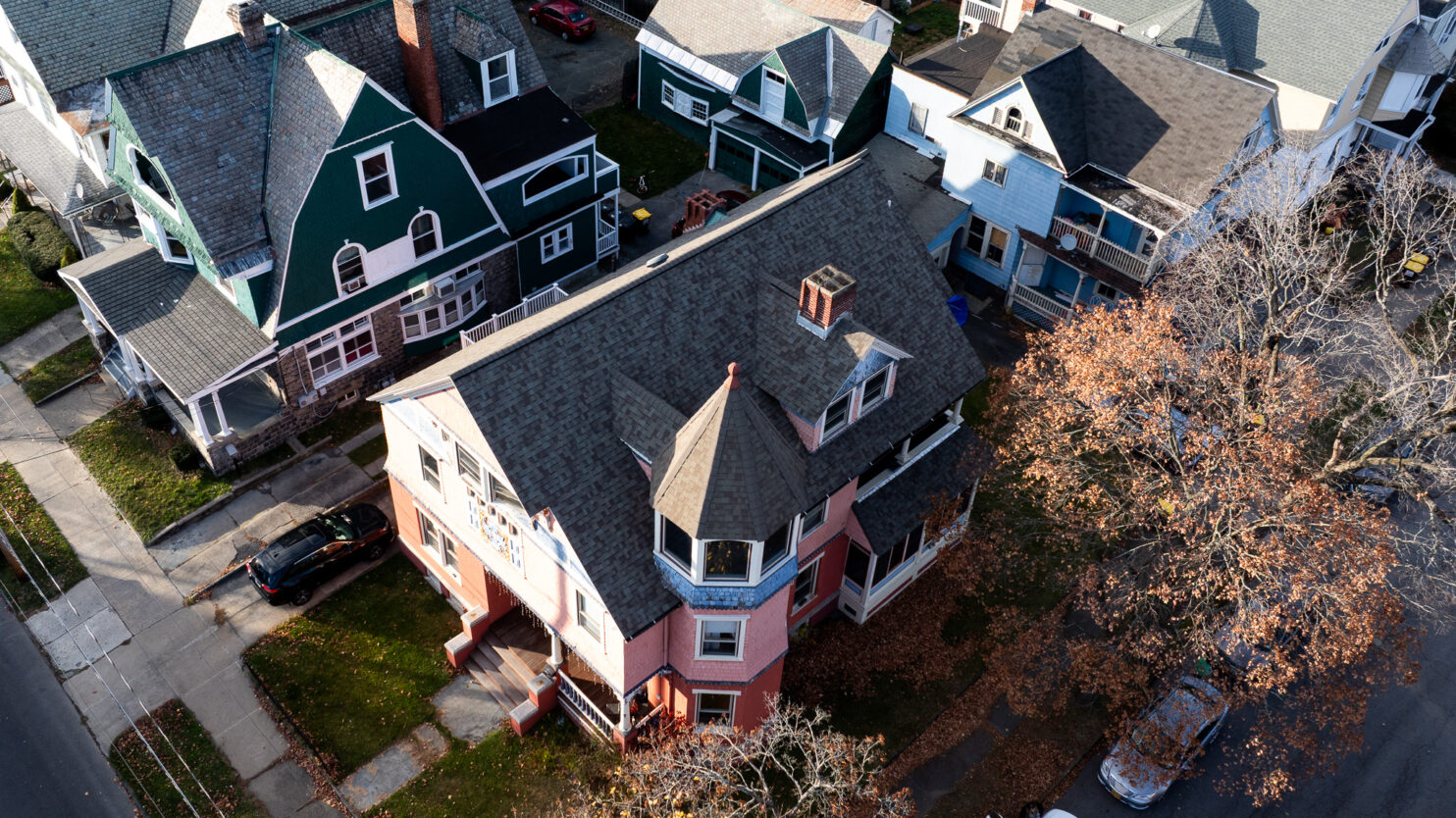 Roofing contractor inspecting shingles on a Fishkill, NY home