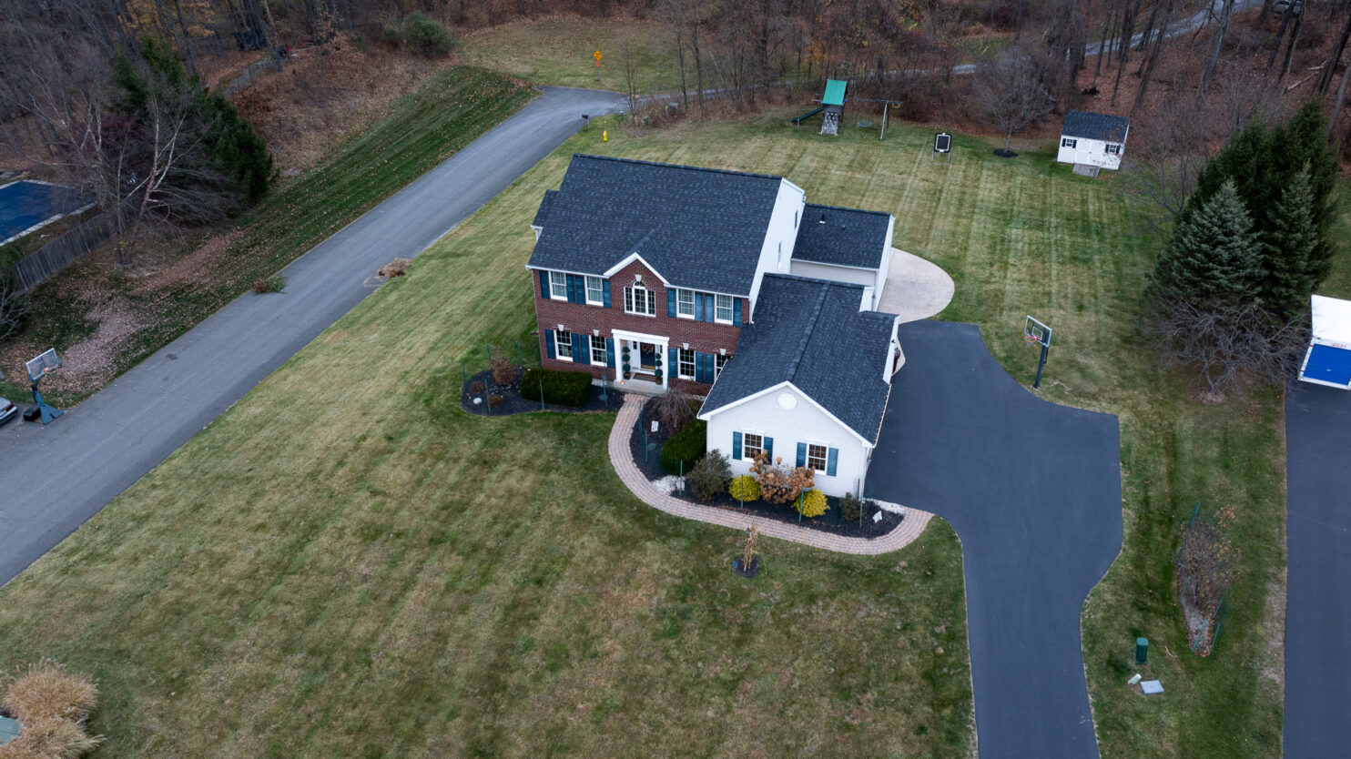: Roof replacement project on a residential home in Utica NY with new asphalt shingles installed by professional roofers