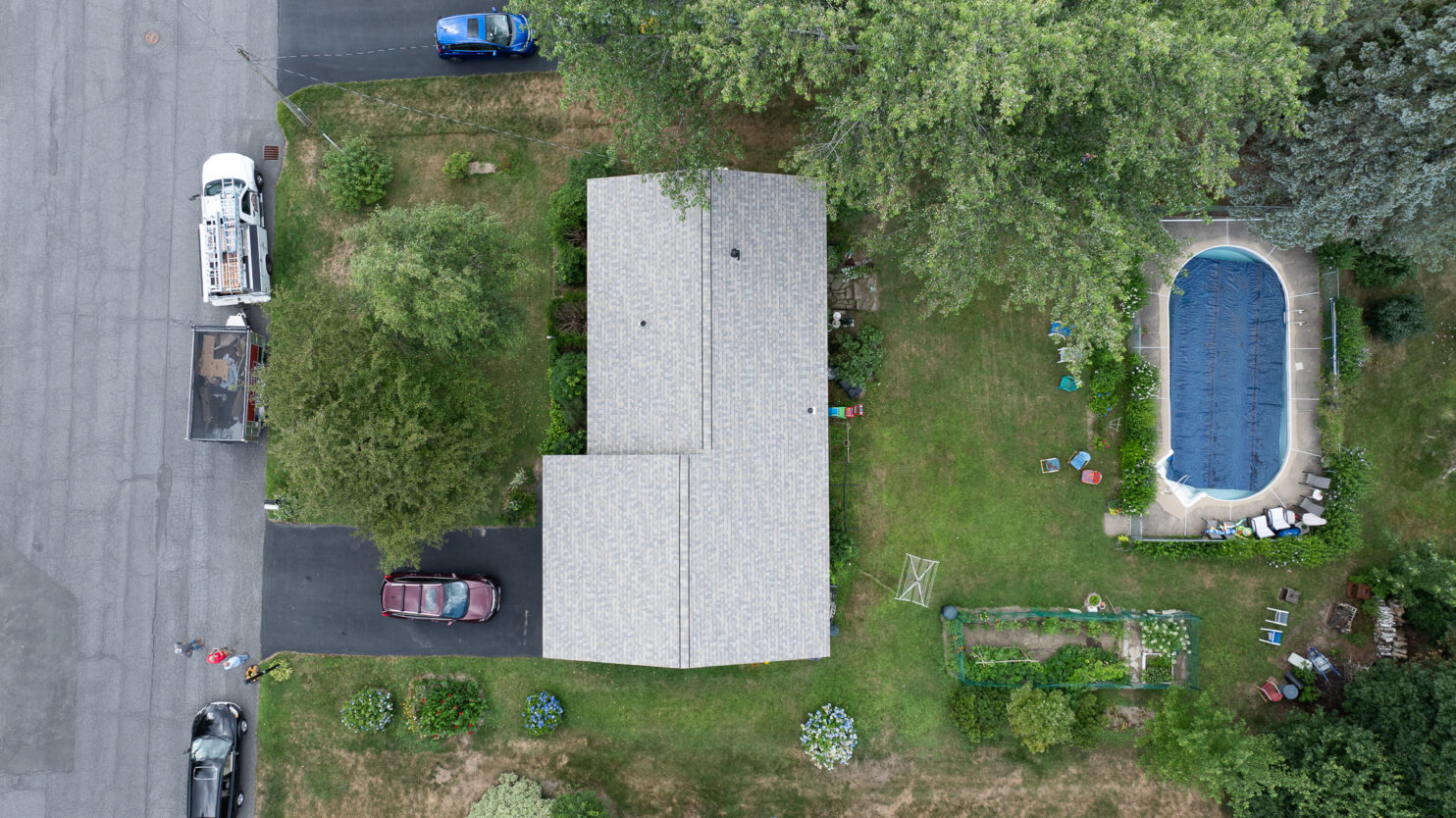 Roofing contractor repairing shingles on a Saratoga Springs home in fall