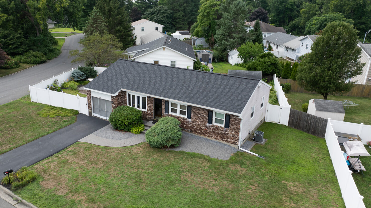 Professional roofers working on a Poughkeepsie home roof replacement