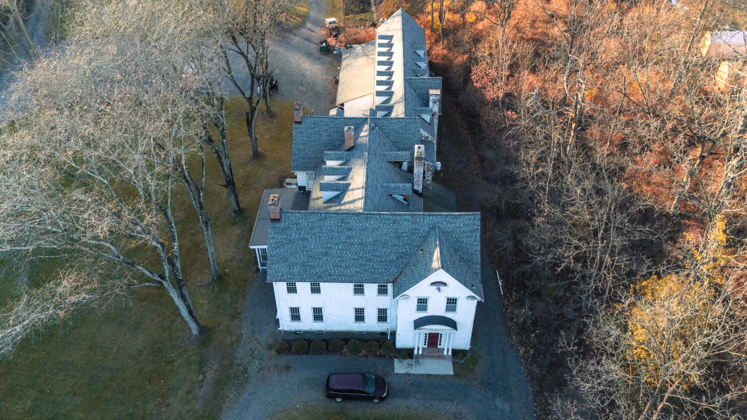 Roof replacement project in Albany County with autumn trees in background