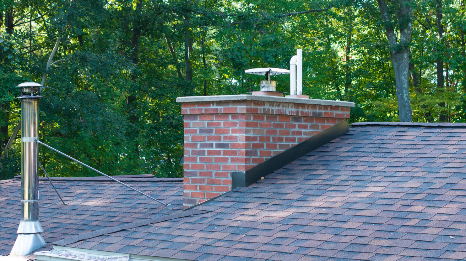Technician performing chimney repair on a historic home in Rhinebeck NY