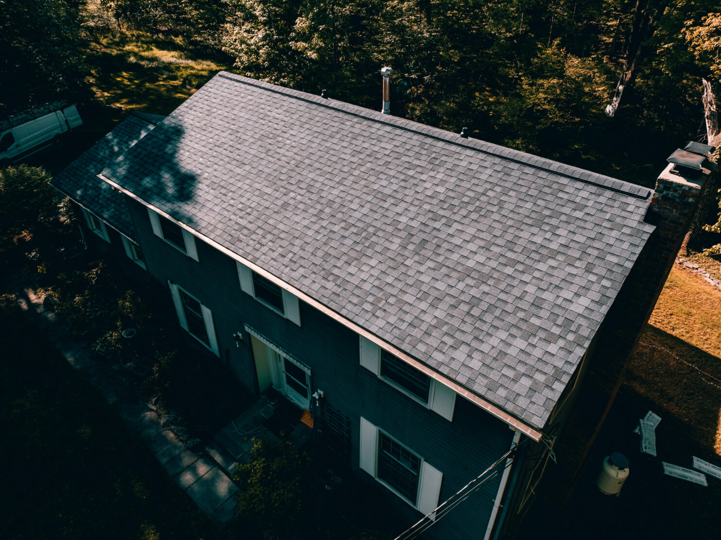 Roofing contractor repairing shingles on a Red Hook NY home before winter.