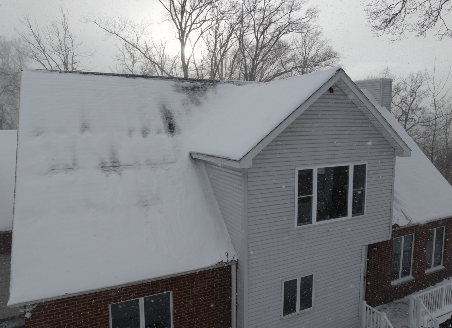 Winter roof repair on Utica NY home with snow and ice damage