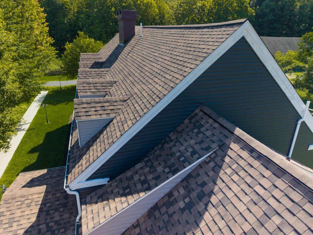 Close-up of IKO Dynasty Brownstone architectural shingles on farmhouse dormers and gables