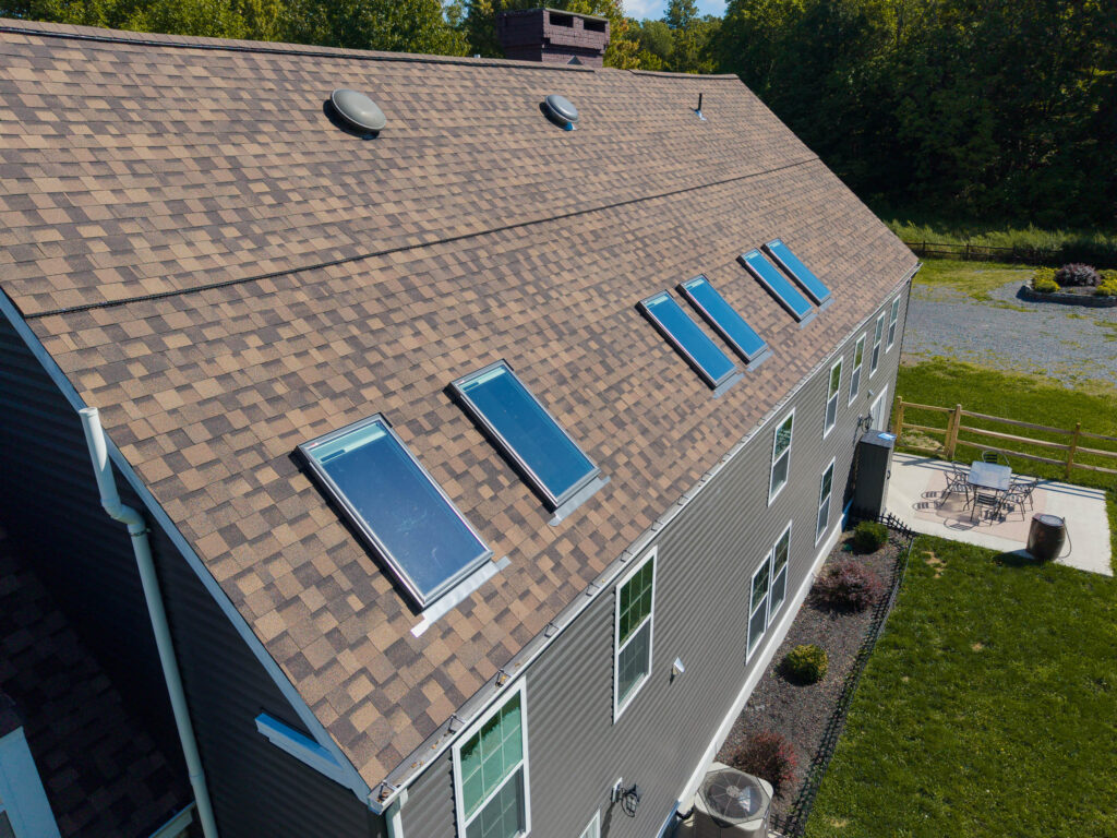 Row of VELUX skylights installed on a new asphalt shingle roof in Kingston NY