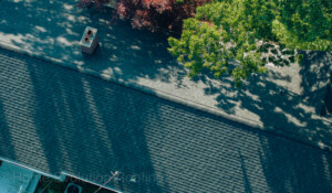 Wind and storm-damaged roof repair in Clifton Park, NY, replacing missing shingles.