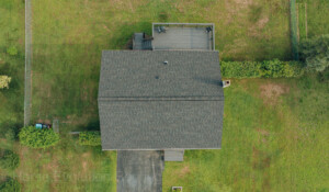 Hail-damaged roof repair in Gloversville, NY, restoring shingle integrity.