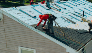 Emergency wind-damaged roof repair in Ballston Spa, NY, replacing torn shingles.